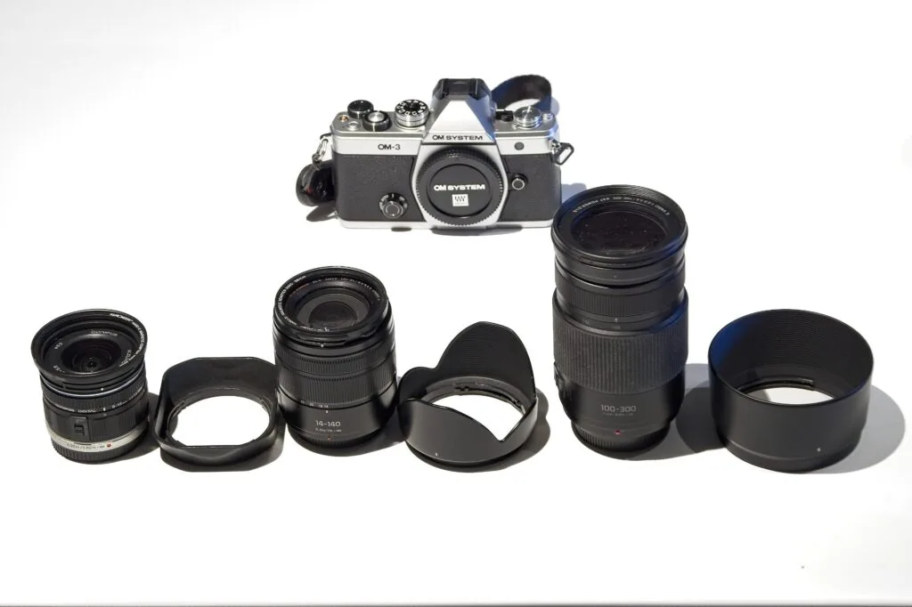 Best lenses for the new OM-3 camera Home Three lightweight travel zoom lenses for the OM-3: Olympus 9-18mm wide angle, Panasonic 14-140mm superzoom, and Panasonic 100-300mm telephoto — covering 18-600mm FFE
